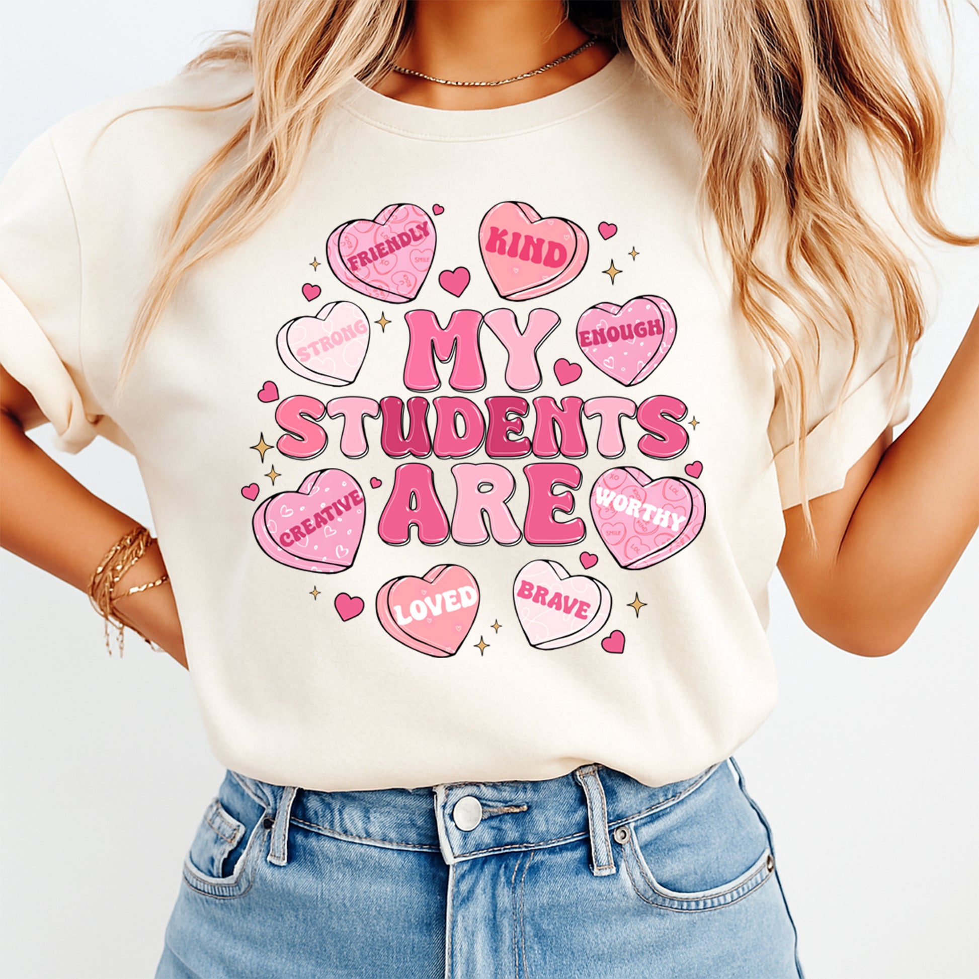 Woman wearing My Students Are teacher Valentine shirt with pink candy heart affirmation graphic