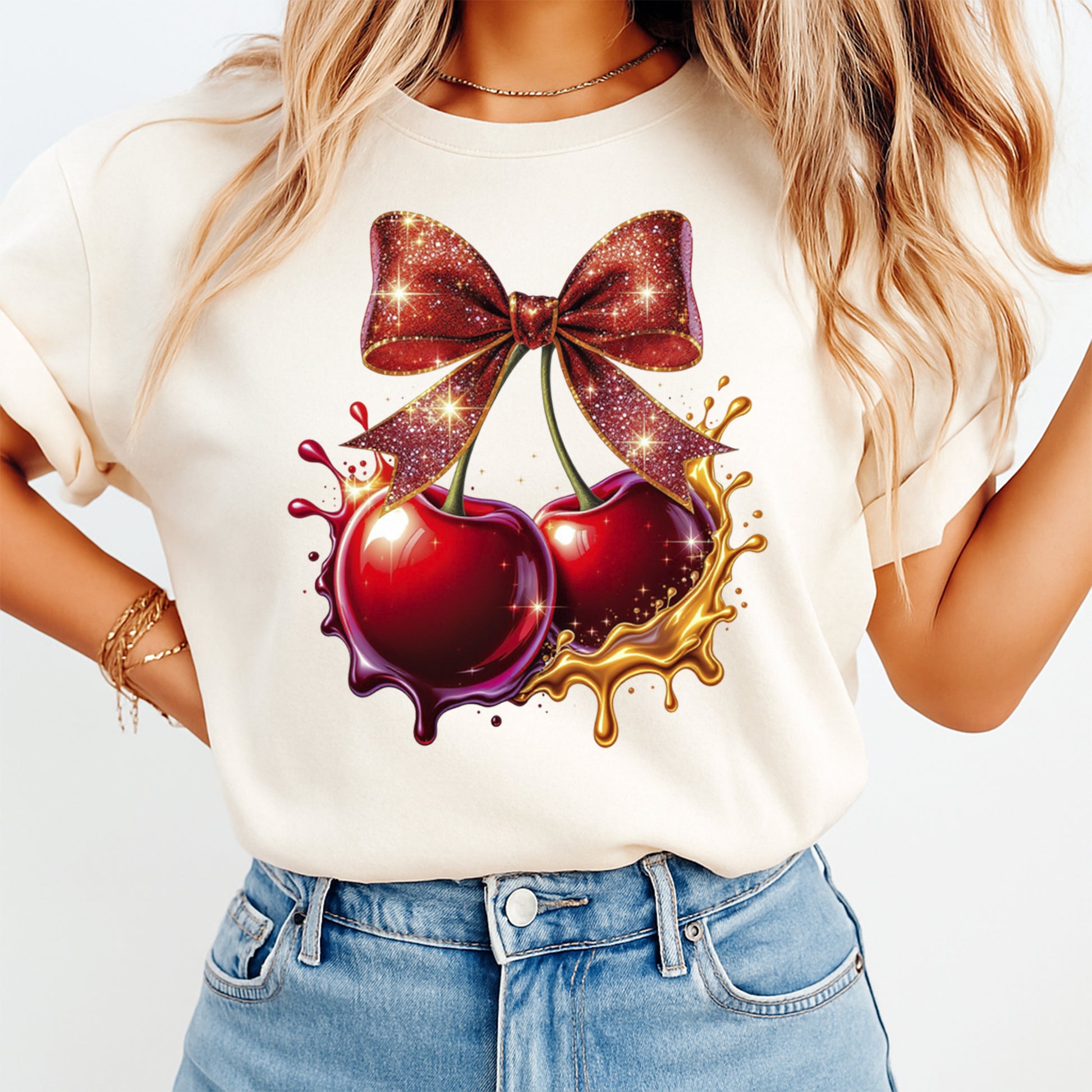 Red cherry bow graphic printed on cream shirt with glitter sparkle and gold paint splash accents