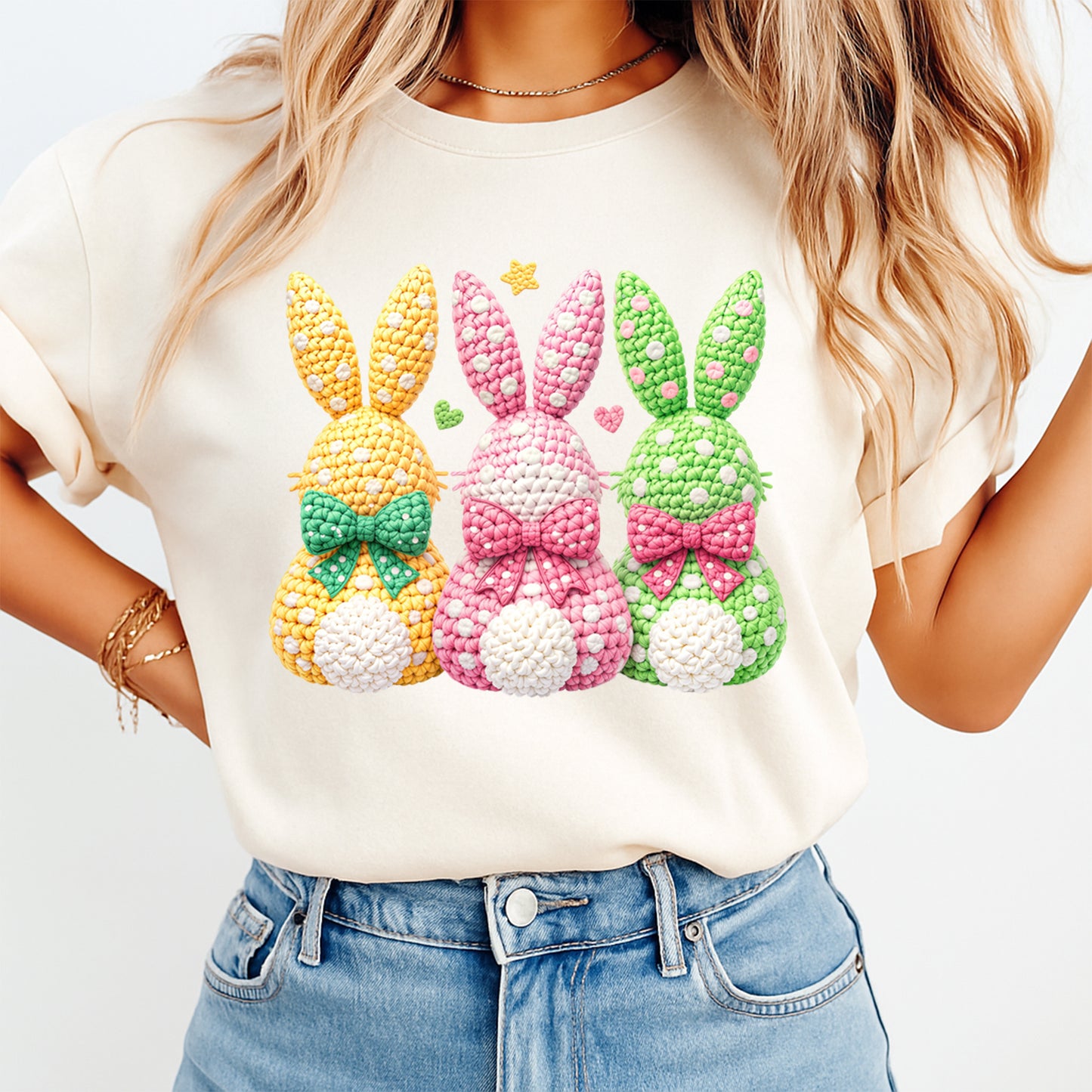 Three pastel crochet style Easter bunnies printed on cream shirt with bow accents and polka dots