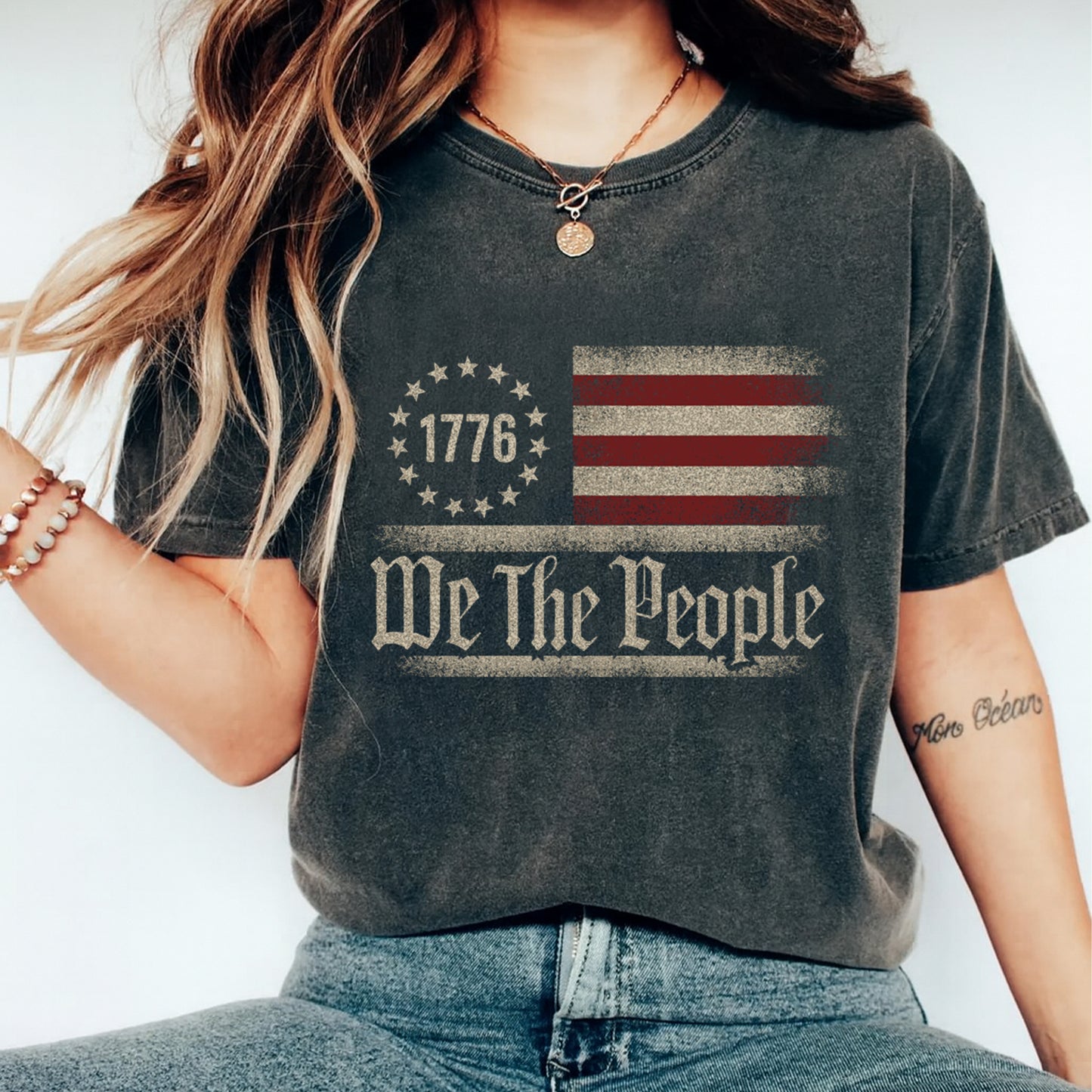 woman wearing shirt with 1776 we the people american flag design ready to press dtf transfer applied