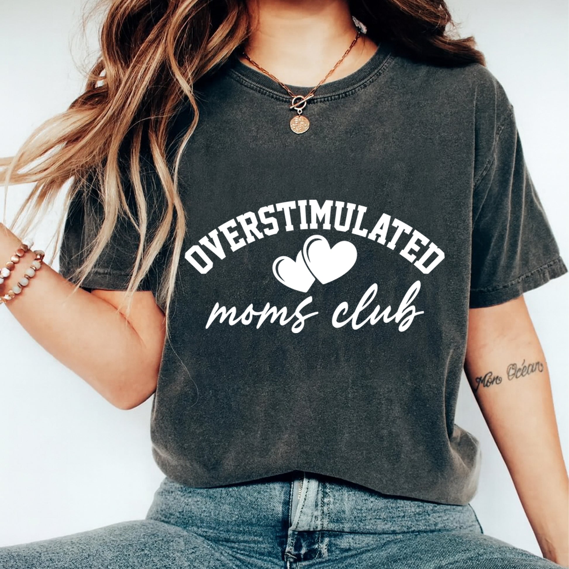 woman wearing dark shirt with overstimulated moms club heart script design ready to press dtf transfer funny mom graphic