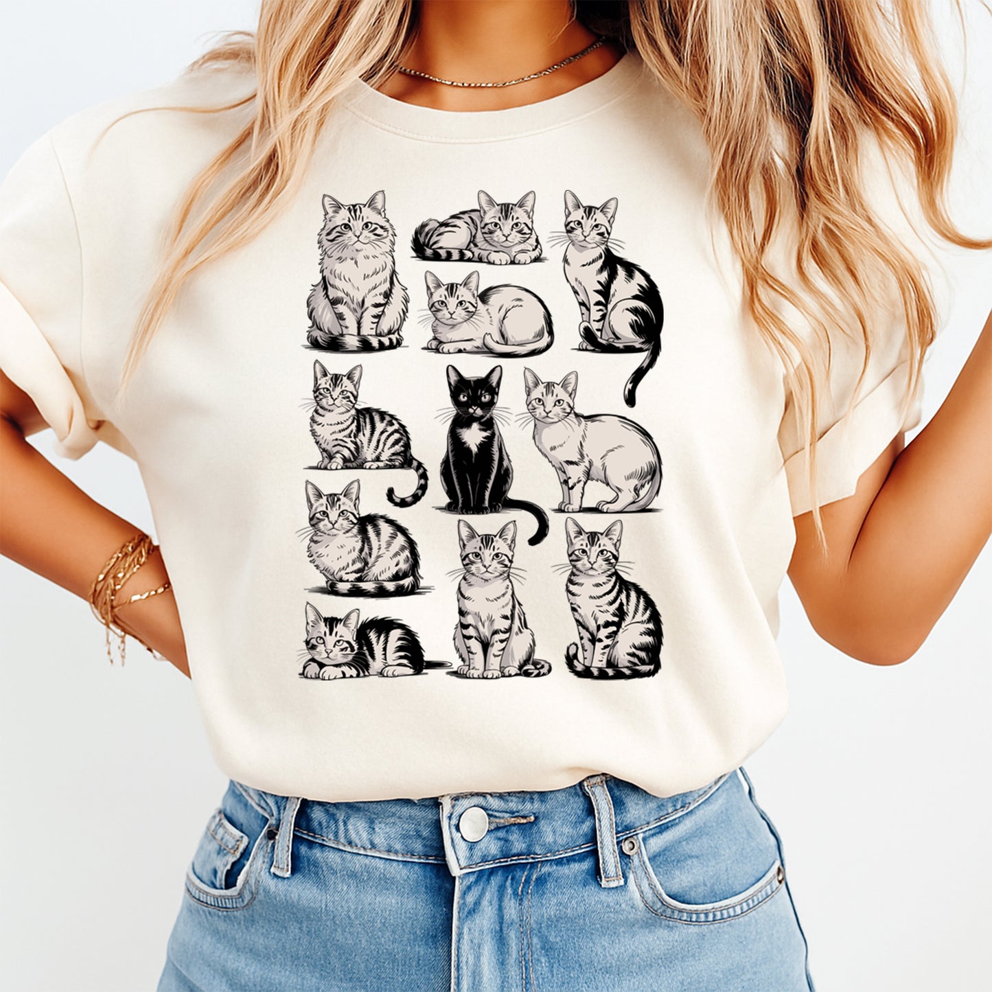 woman wearing beige shirt with cat illustration dtf transfer featuring multiple kitten poses in a grid layout