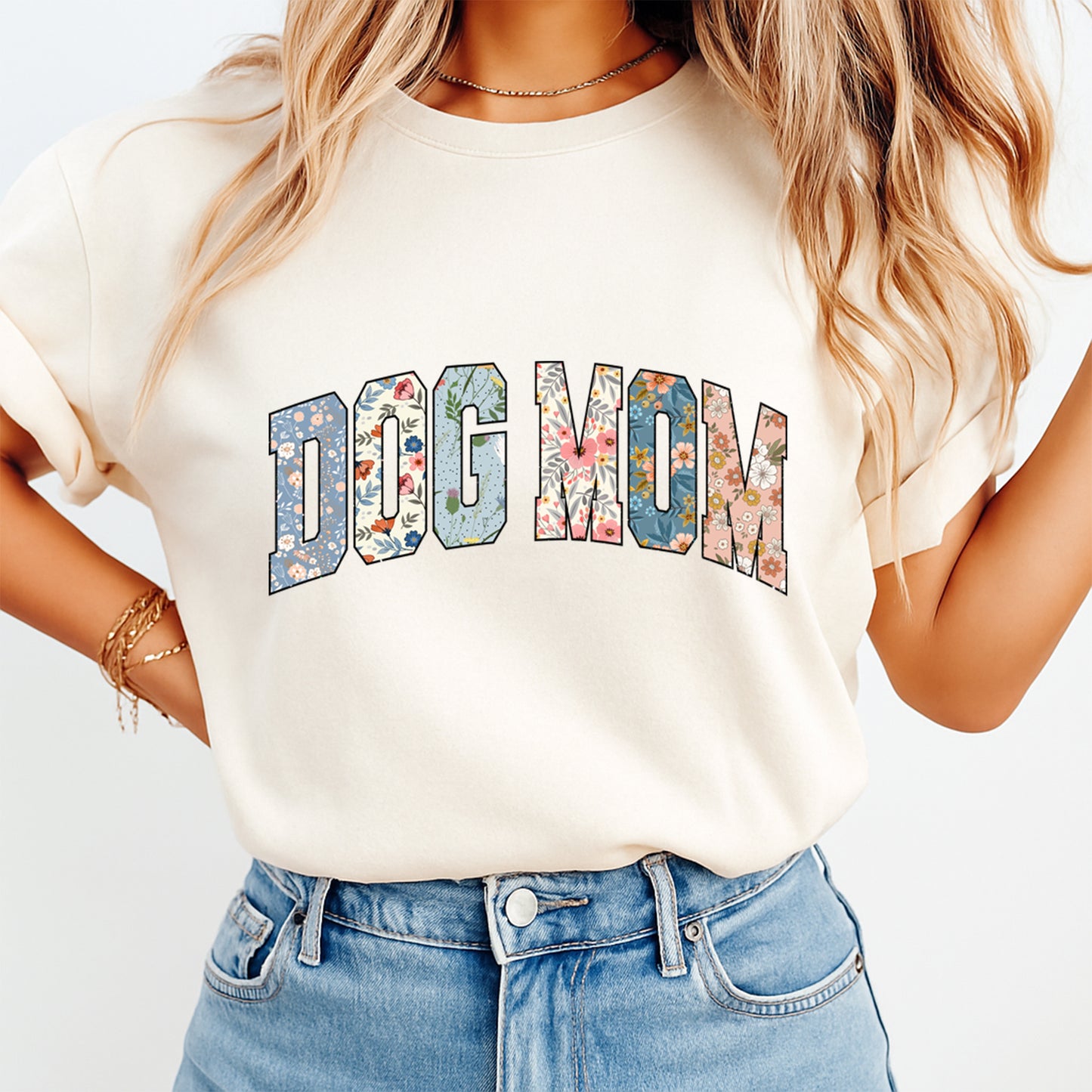 woman wearing beige shirt with dog mom floral text dtf transfer design in colorful patterned lettering
