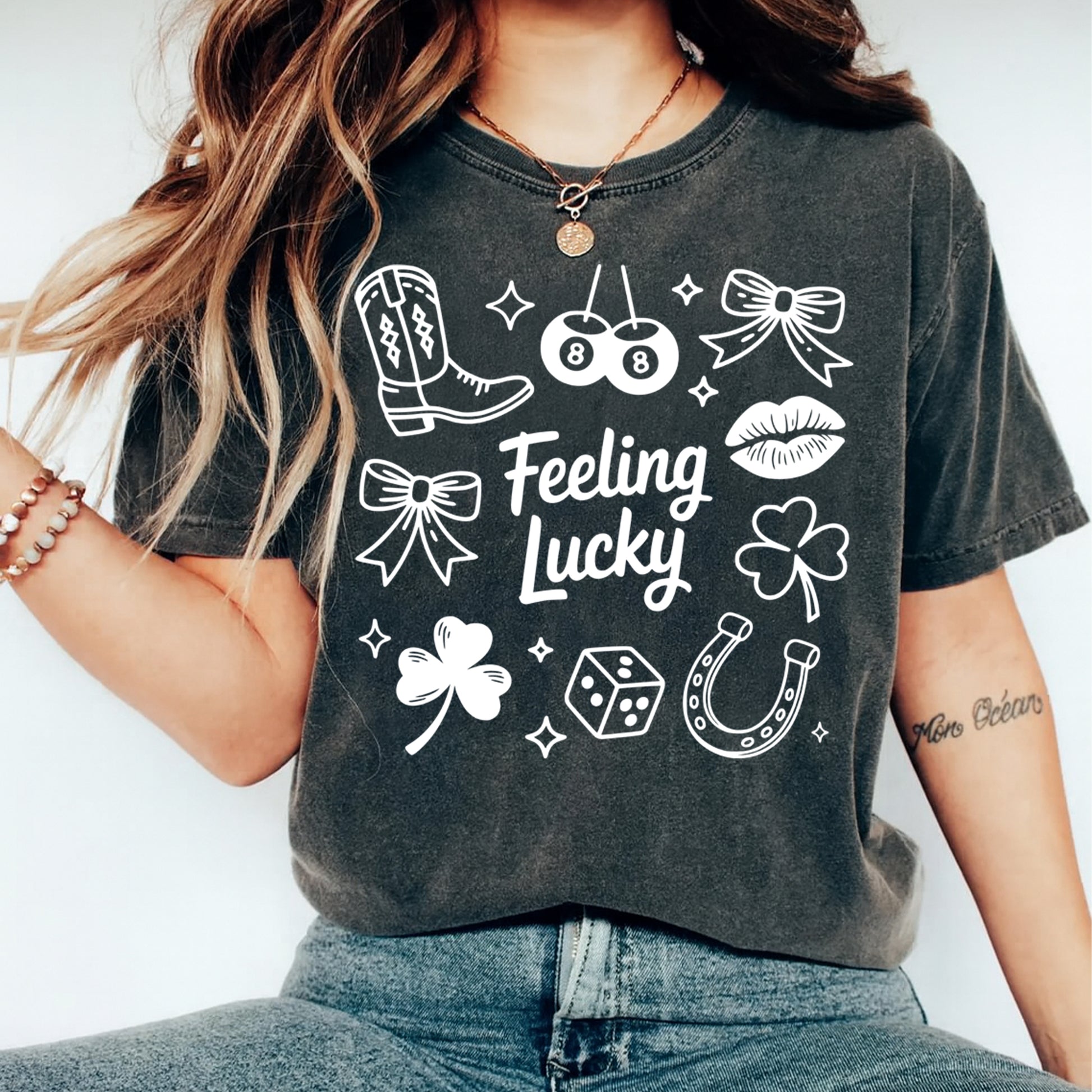 woman wearing dark shirt with feeling lucky dtf transfer featuring western icons like boots clovers cherries and bows