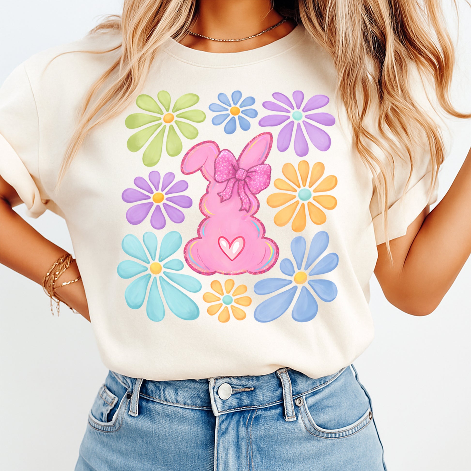 woman wearing beige shirt with pink bunny dtf transfer surrounded by colorful flowers and spring theme design