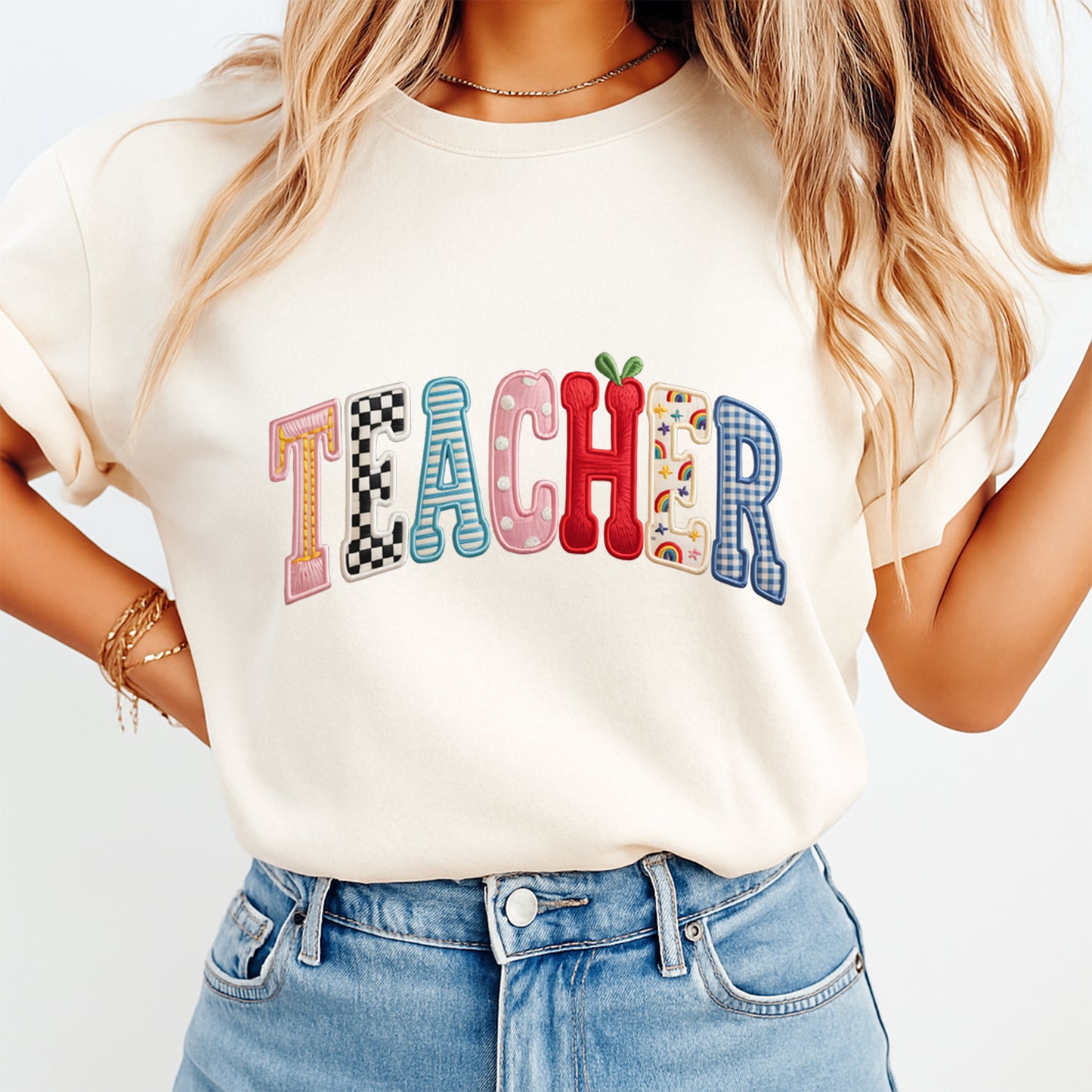 woman wearing teacher shirt with colorful patchwork letters ready to press dtf transfer playful classroom design on beige tee
