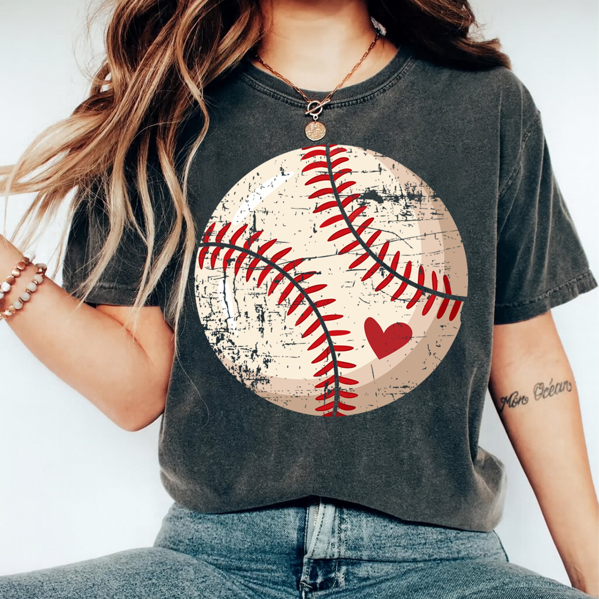 woman wearing vintage baseball graphic shirt with distressed ball and heart ready to press dtf transfer