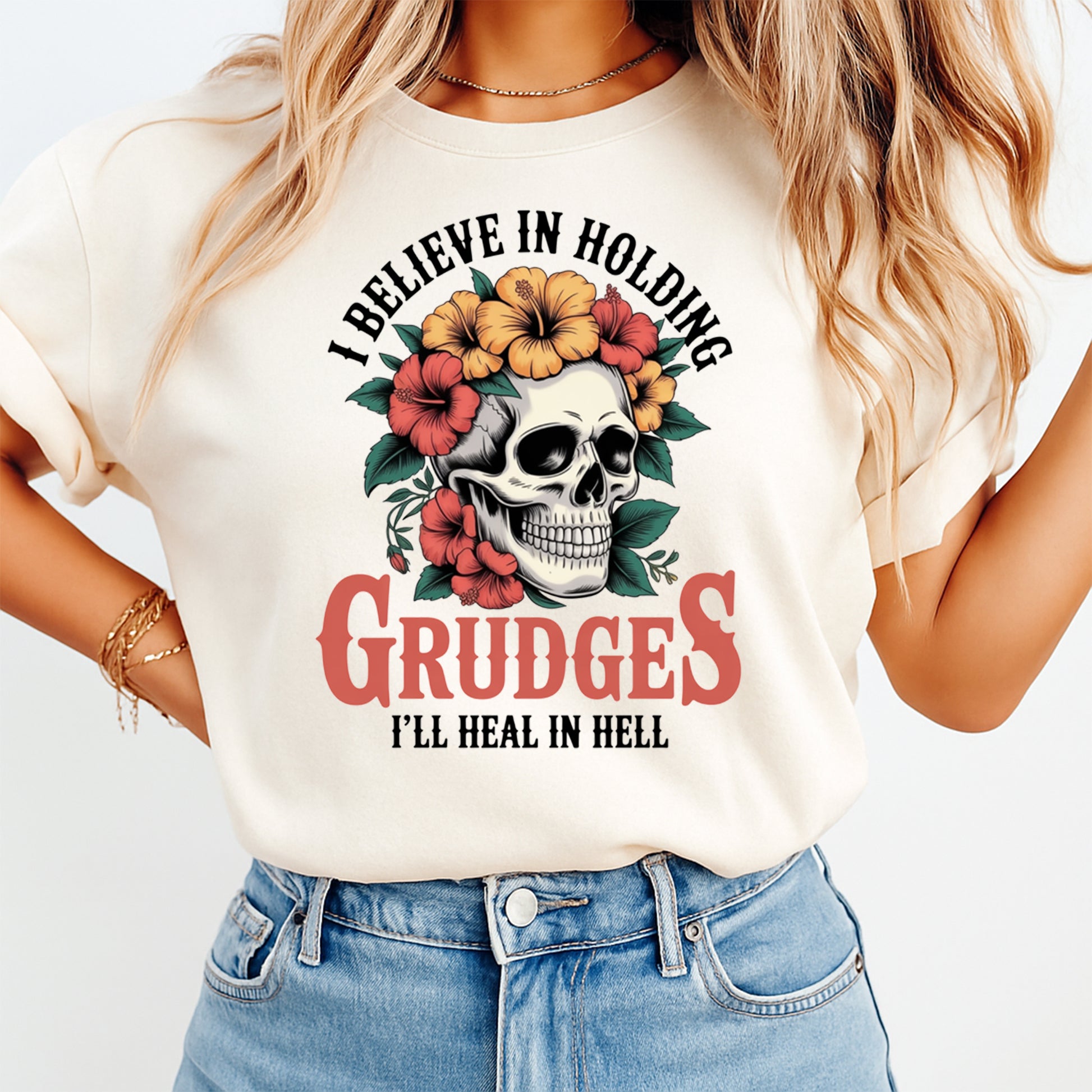Woman wearing a cream shirt with a gothic skull floral ready to press dtf graphic and sarcastic quote on the front