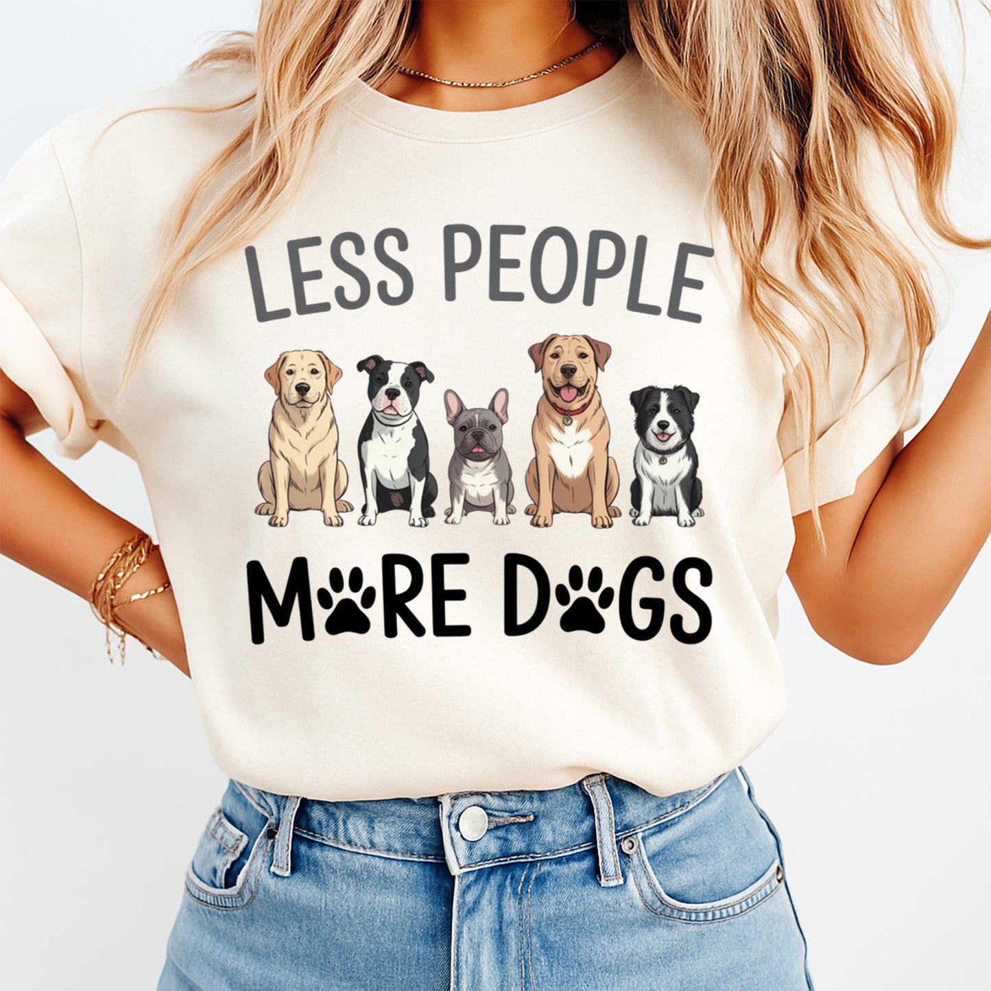 Woman wearing a cream shirt with less people more dogs quote and a lineup of cute dog illustrations, ready to press dtf mockup