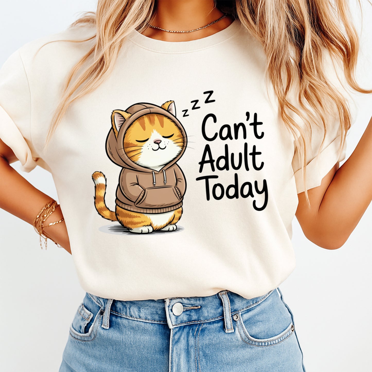 Mockup shirt featuring a sleepy orange cat in a brown hoodie with the phrase Can’t Adult Today