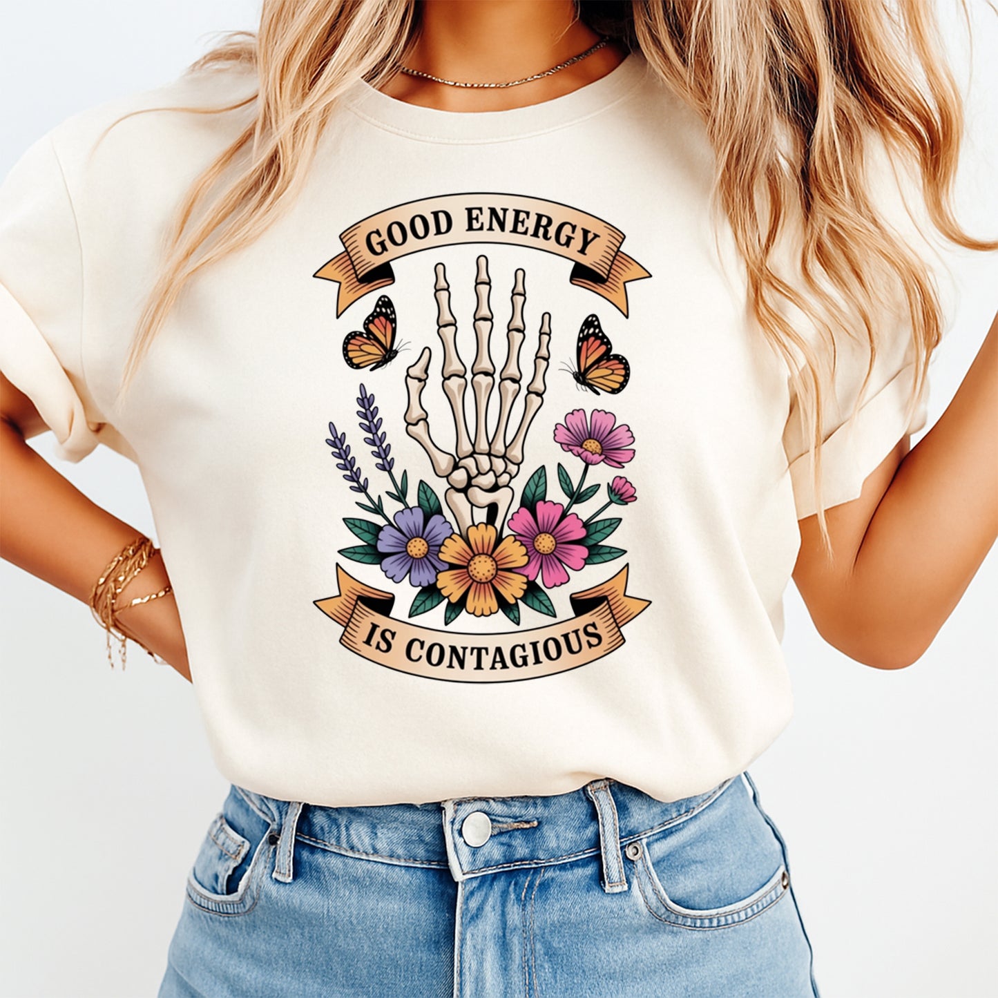 Mockup shirt featuring a skeleton hand with colorful flowers butterflies and the phrase Good Energy Is Contagious