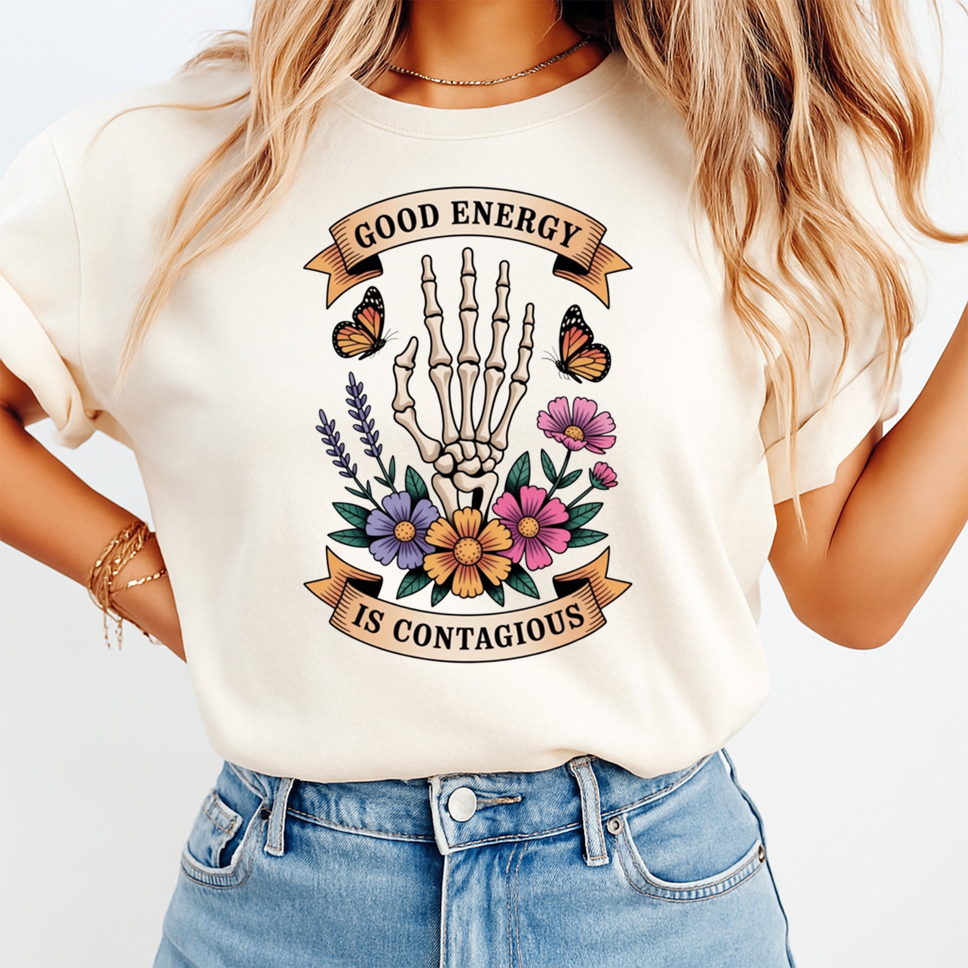 Mockup shirt featuring a skeleton hand with colorful flowers butterflies and the phrase Good Energy Is Contagious