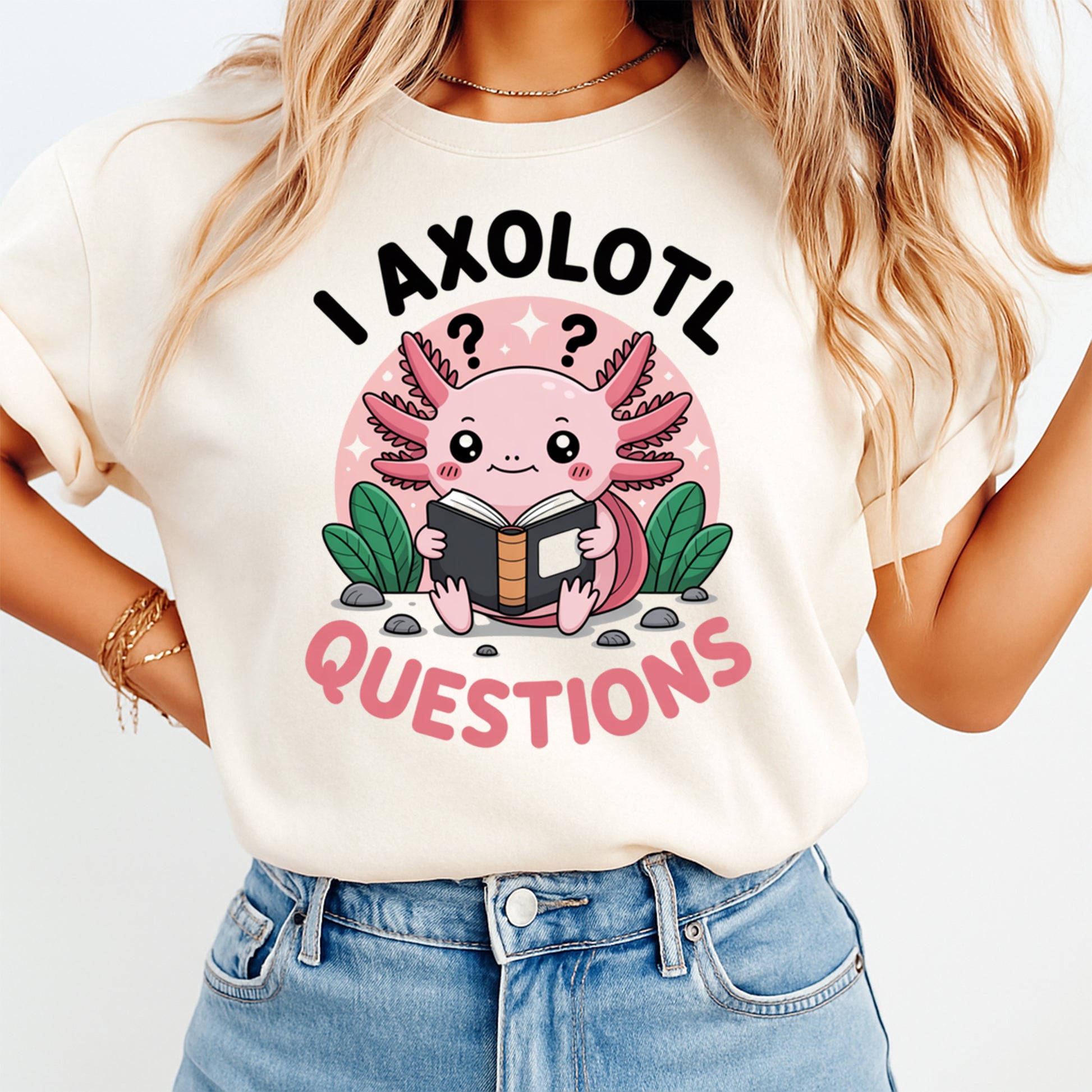 Mockup shirt featuring a cute pink axolotl holding a book with the phrase I Axolotl Questions