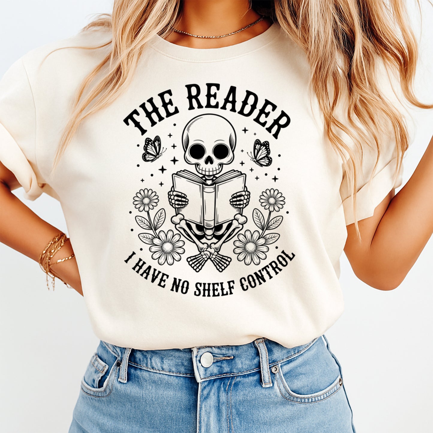 Book lover ready to press dtf transfer mockup on cream shirt with skeleton reading a book, flowers, butterflies, and black quote text.