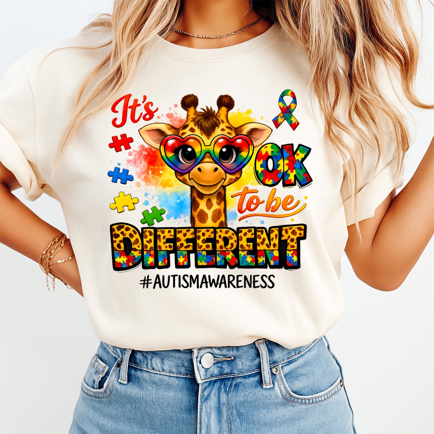 Mockup of autism awareness ready to press dtf transfer on a cream shirt featuring giraffe with rainbow heart glasses, puzzle accents, and awareness quote for DIY autism shirts.