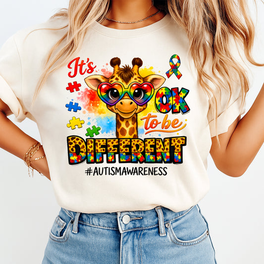 Mockup of autism awareness ready to press dtf transfer on a cream shirt featuring giraffe with rainbow heart glasses, puzzle accents, and awareness quote for DIY autism shirts.