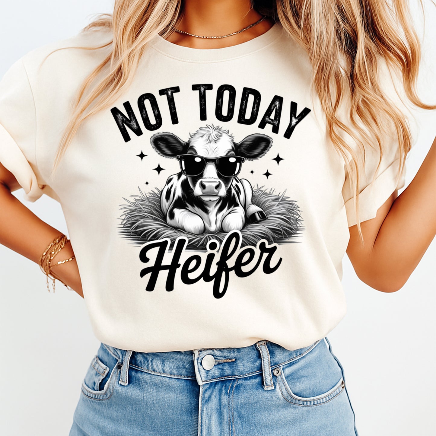 Mockup of a cream shirt featuring a funny cow ready to press dtf transfer with a calf wearing sunglasses and the phrase Not Today Heifer.