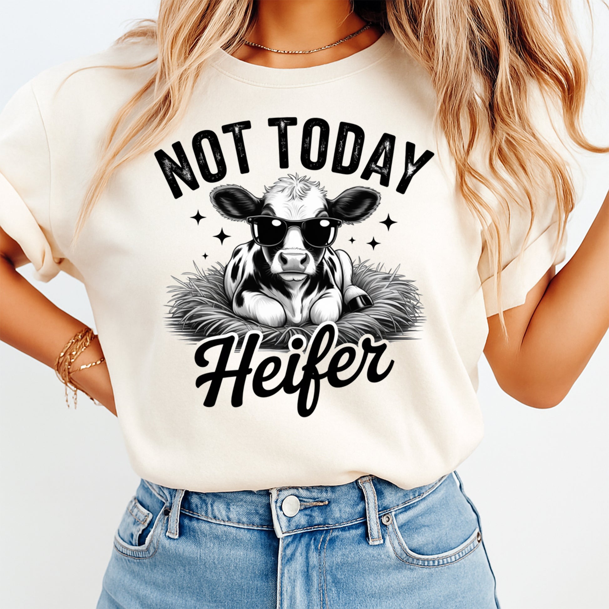 Mockup of a cream shirt featuring a funny cow ready to press dtf transfer with a calf wearing sunglasses and the phrase Not Today Heifer.