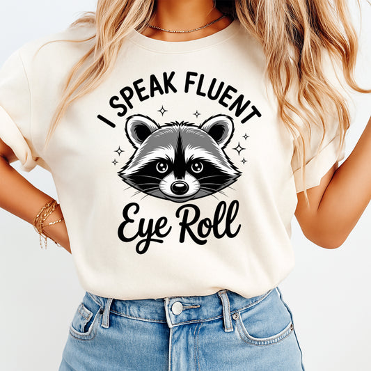 Mockup-style product image featuring a sarcastic raccoon ready to press dtf transfer with the phrase I Speak Fluent Eye Roll on a wood background.