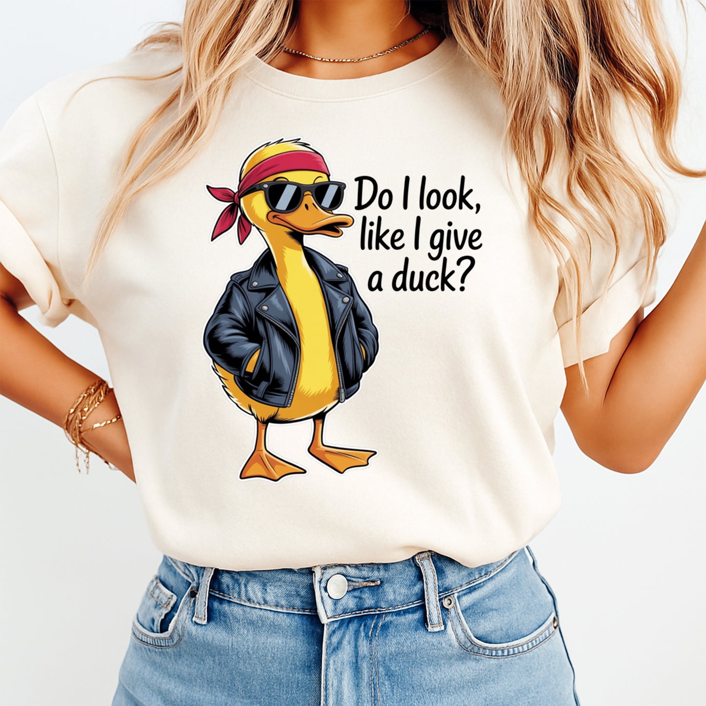 Mockup of a cream shirt featuring a sarcastic duck ready to press dtf transfer with the phrase Do I look like I give a duck, sunglasses, red bandana, and black jacket.