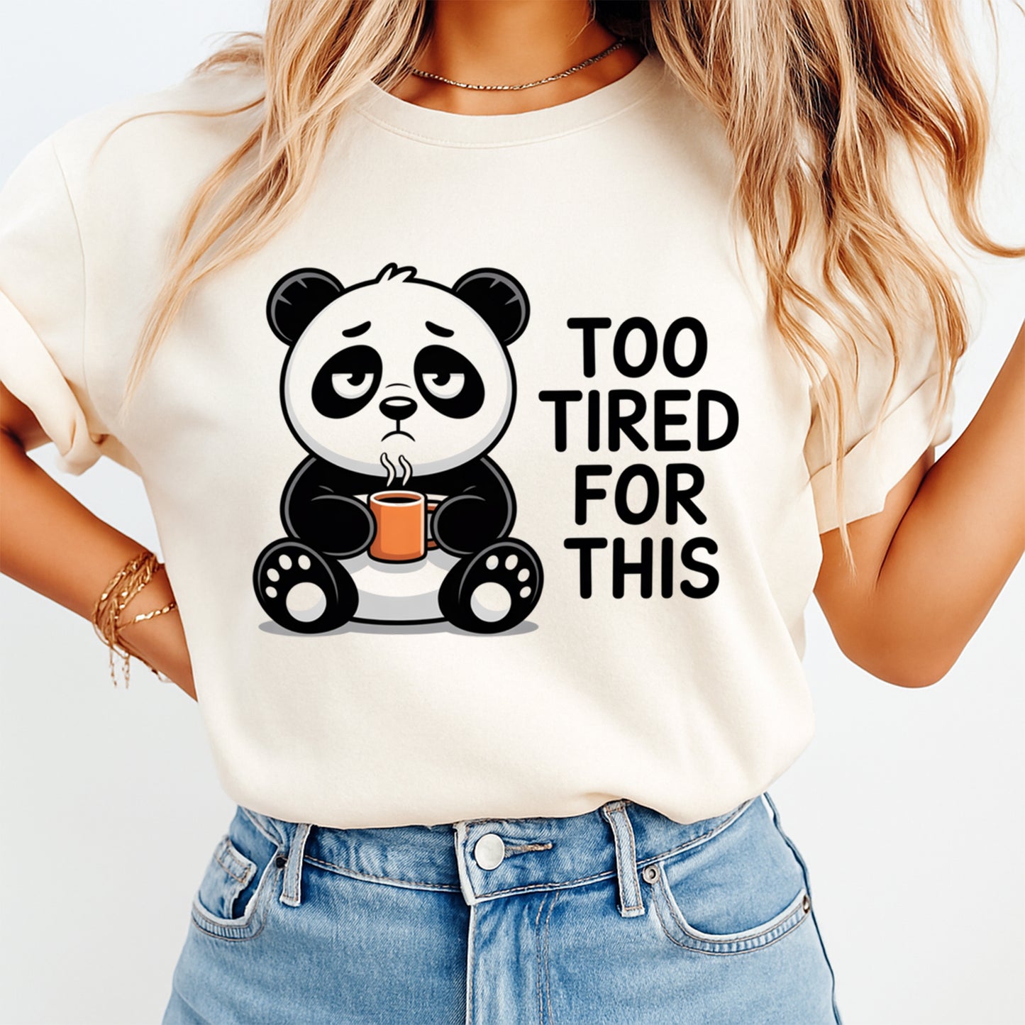 Mockup of a cream shirt featuring a funny panda ready to press dtf transfer with a tired panda holding a coffee mug and the phrase Too Tired For This.