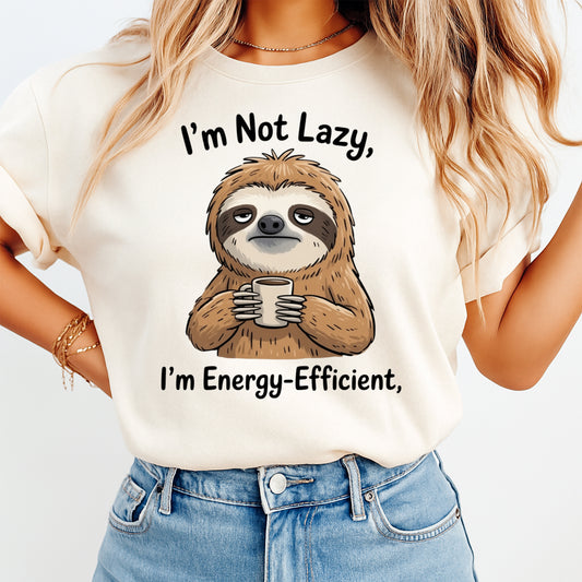 Mockup of a cream shirt featuring a funny sloth ready to press dtf transfer with coffee mug and the phrase I’m Not Lazy, I’m Energy-Efficient.