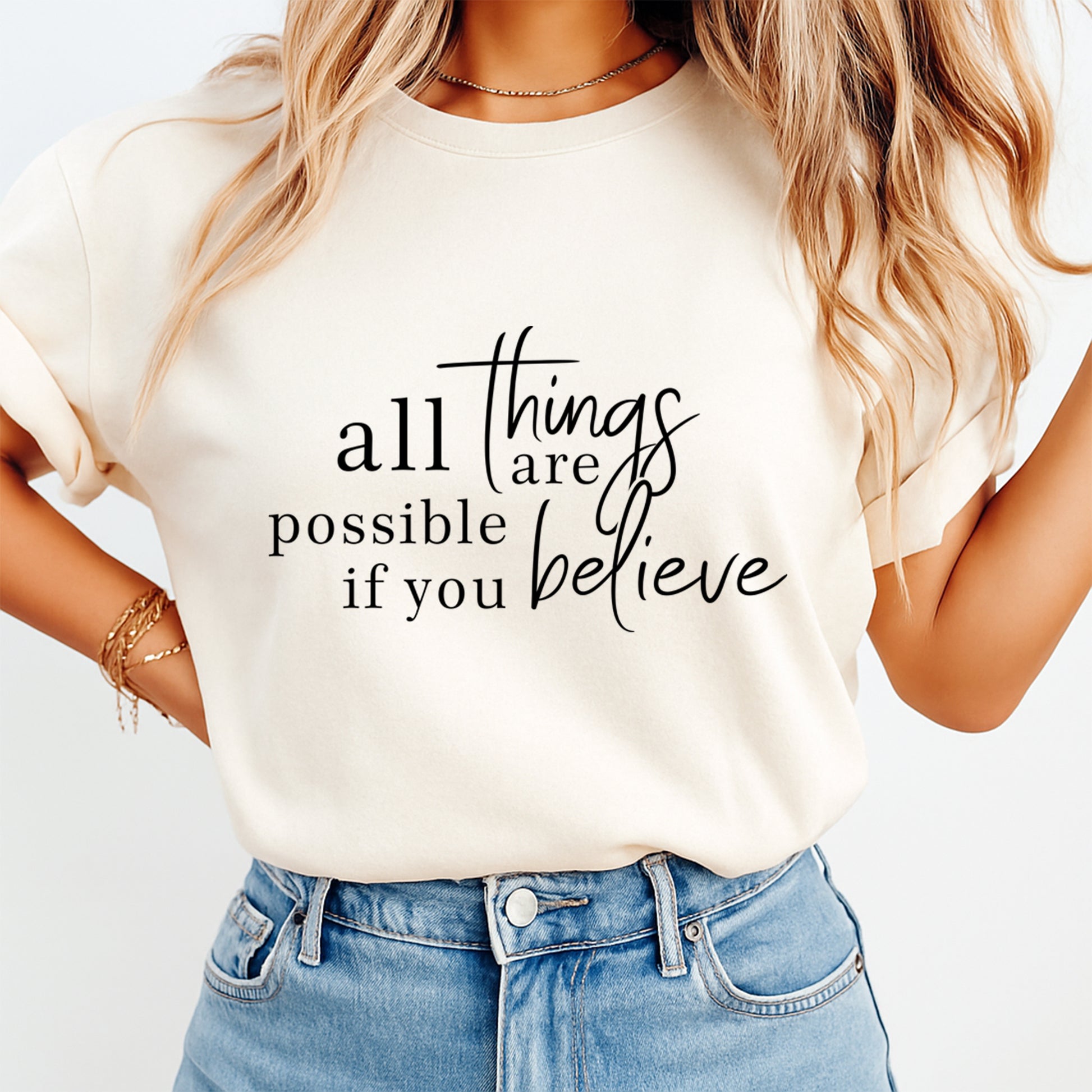 Mockup of a cream shirt featuring an inspirational quote ready to press dtf transfer with the phrase all things are possible if you believe in elegant black typography.