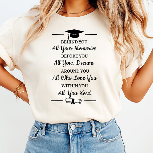 Mockup of a cream shirt featuring a graduation ready to press dtf transfer with a cap, diploma, and the phrase Behind you all your memories before you all your dreams.