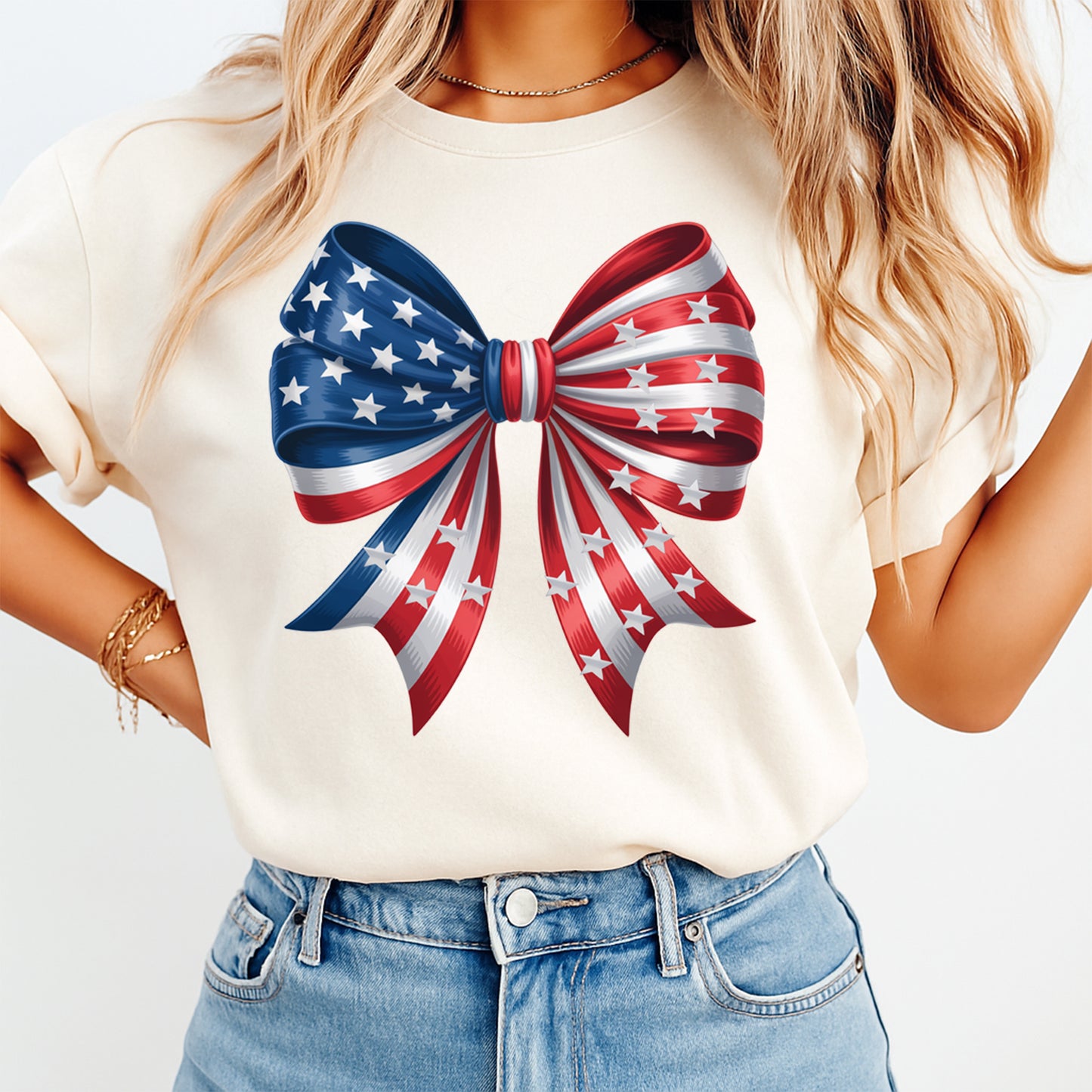Mockup of a cream shirt featuring a patriotic bow ready to press dtf transfer with red, white, and blue stars and stripes ribbon artwork.