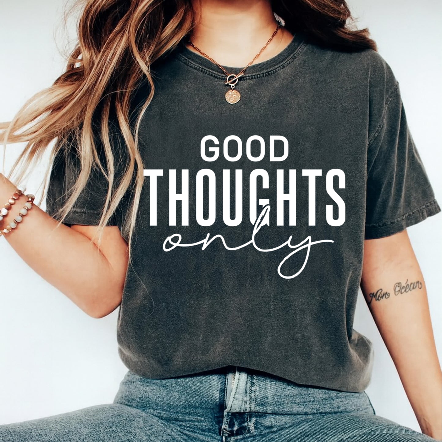 Black shirt mockup featuring a minimalist positive quote ready to press dtf transfer with the phrase Good Thoughts Only in bold white lettering.