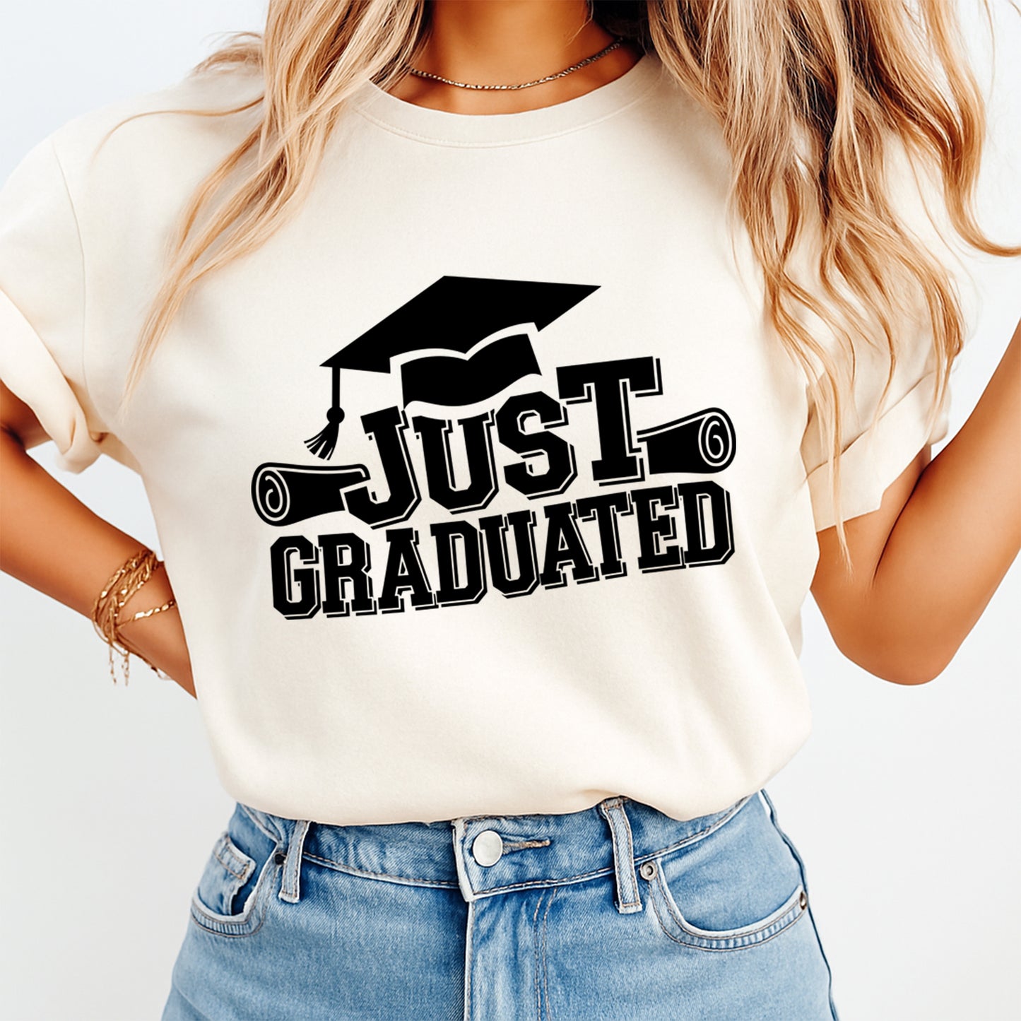 Cream shirt mockup featuring a graduation ready to press dtf transfer with the phrase Just Graduated, varsity lettering, cap, and diploma graphics.