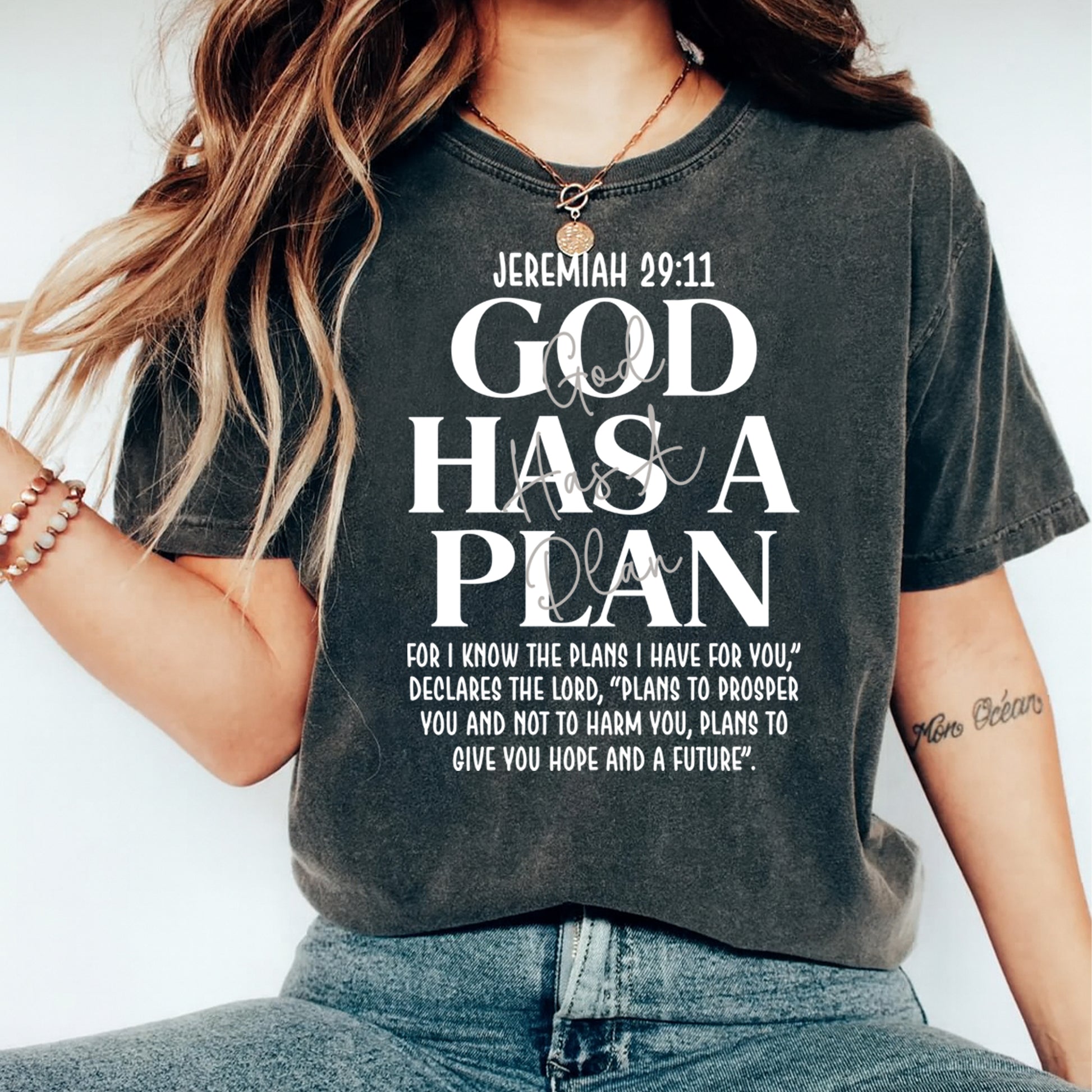 Black shirt mockup featuring a faith ready to press dtf transfer with the phrase God Has a Plan and Jeremiah 29:11 scripture-inspired white typography.