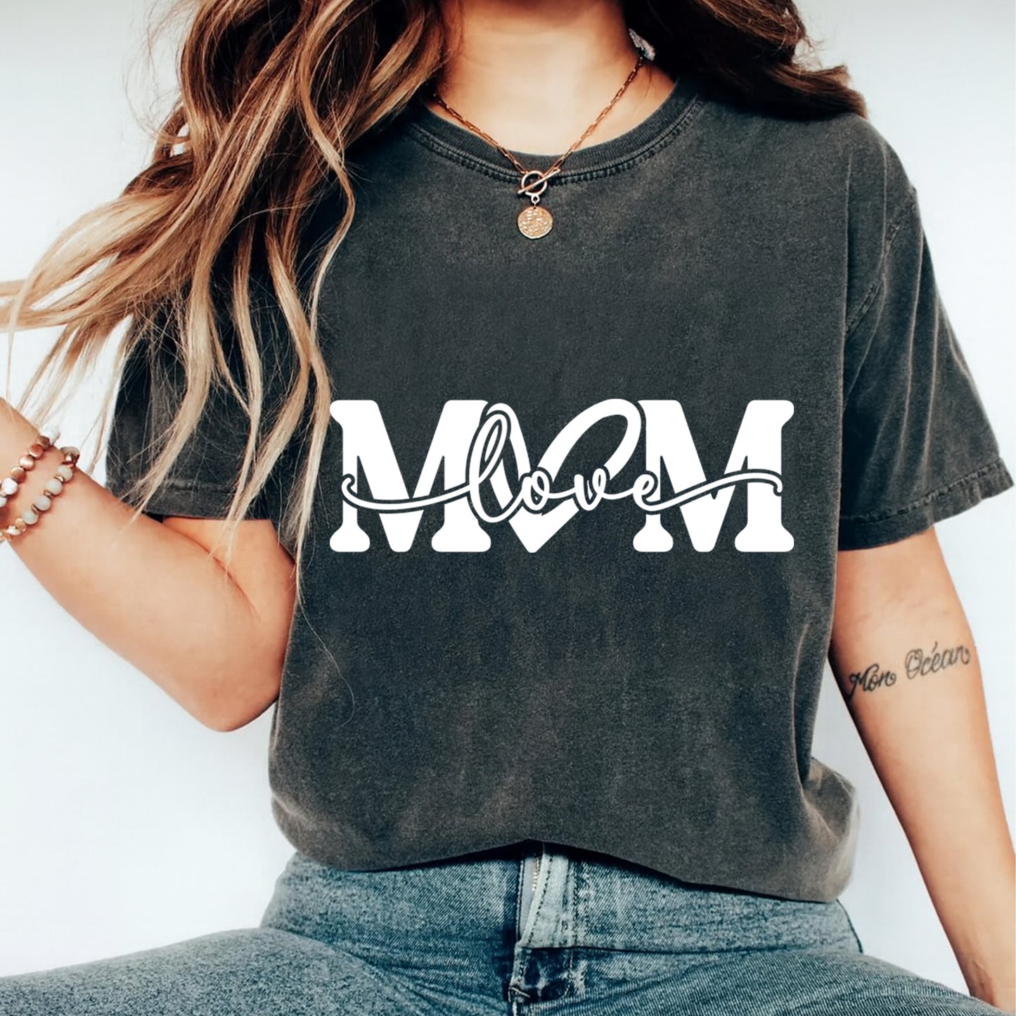 Black shirt mockup featuring a white MOM love ready to press dtf transfer for mom shirts, Mother’s Day apparel, and DIY shirts.