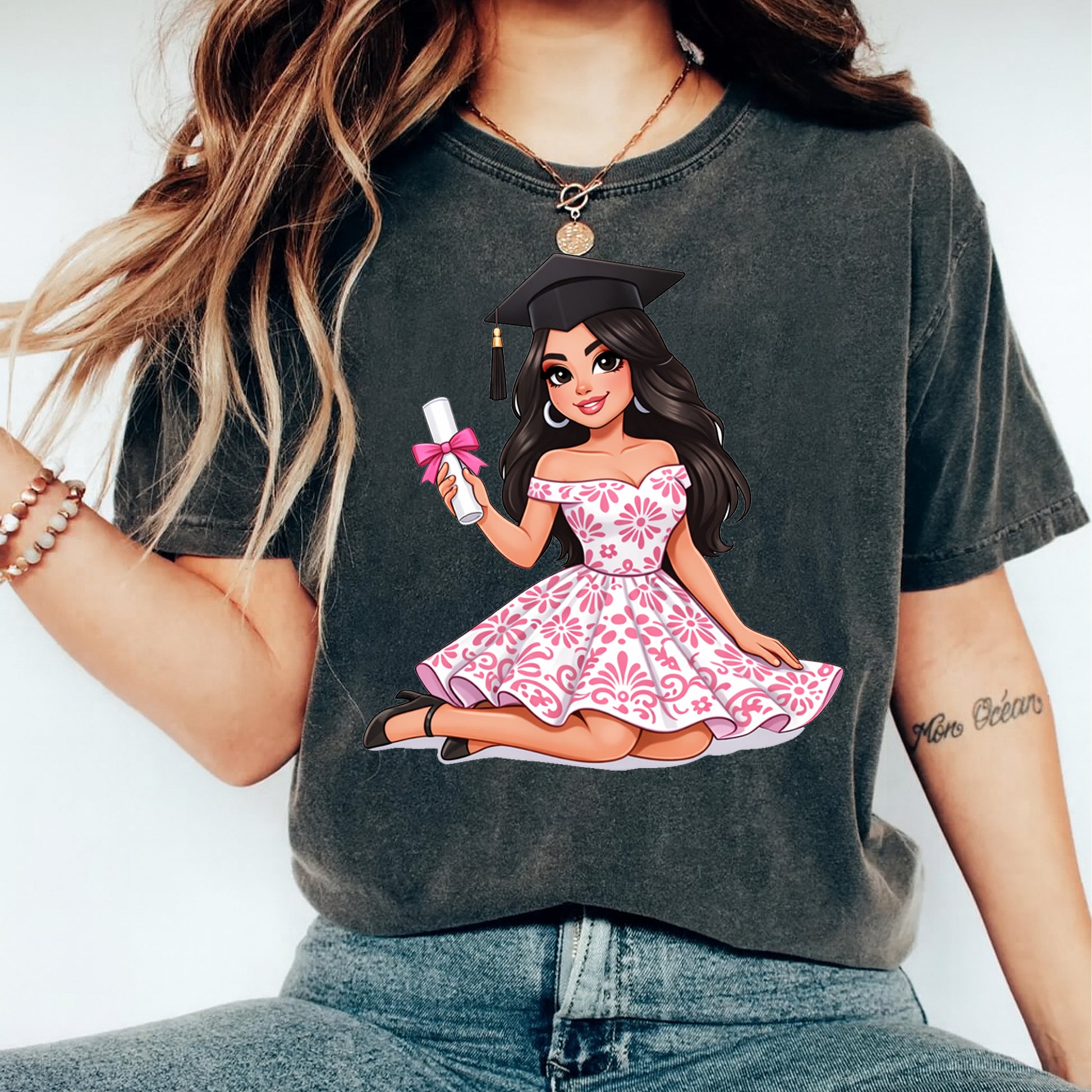 Person wearing a t-shirt with a graphic of a woman in a graduation gown.