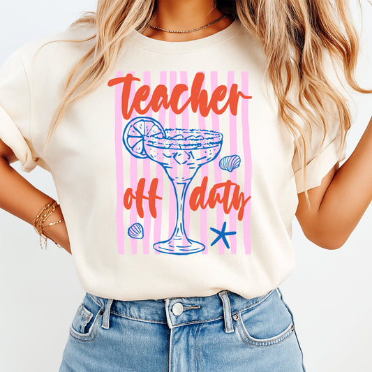 Person wearing a t-shirt with 'Teacher off duty' design on a plain background