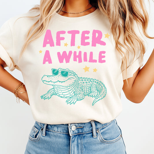 After a While alligator DTF transfer mockup on cream shirt with sunglasses gator design