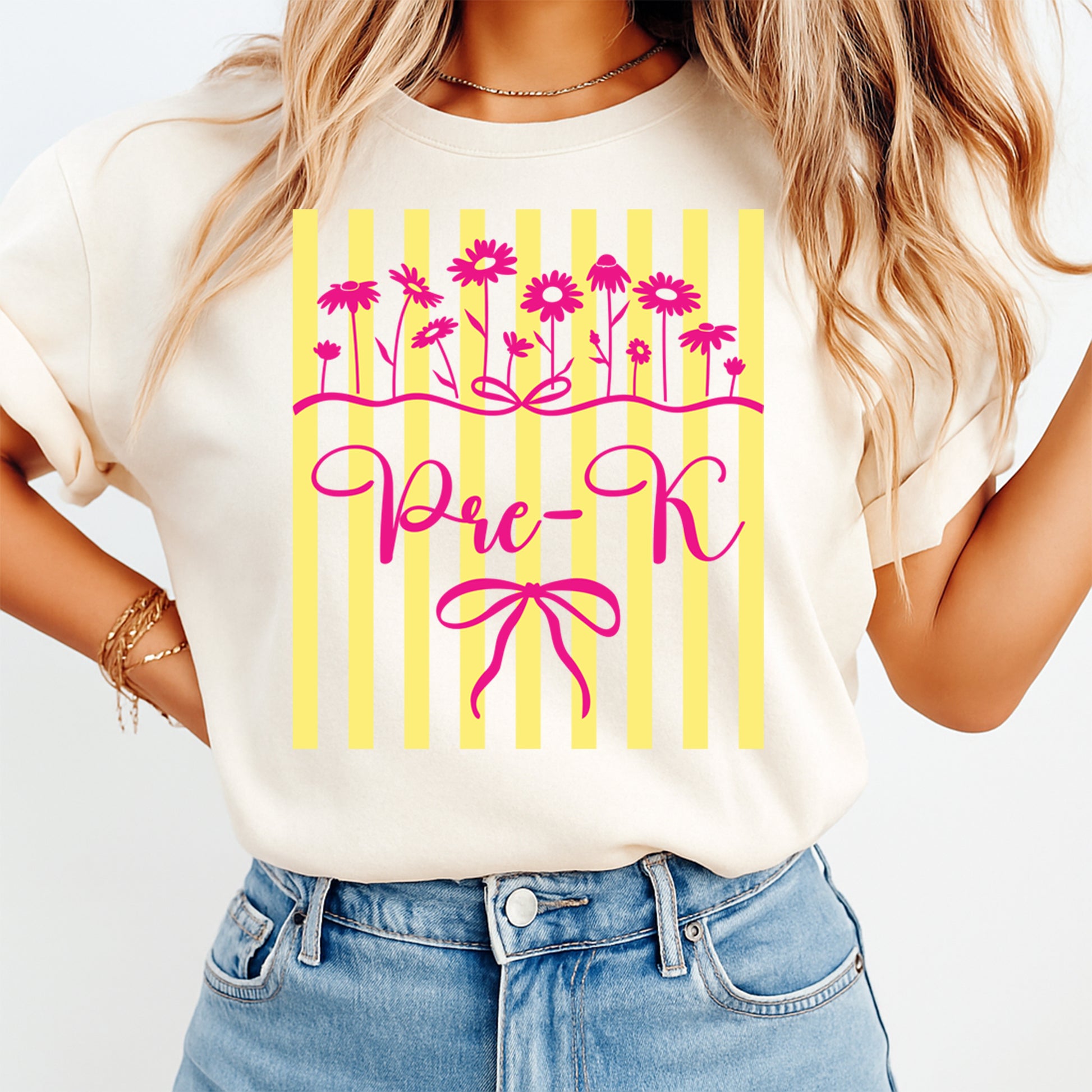 Person wearing a white t-shirt with 'Pre-K' design featuring pink flowers and yellow stripes.