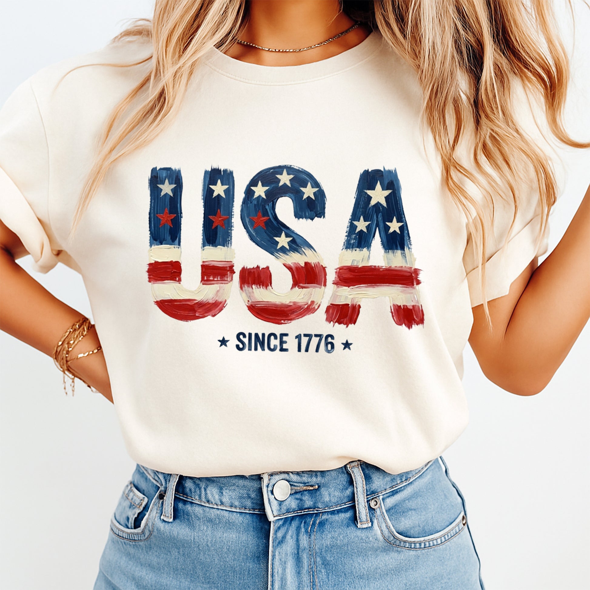 Person wearing a white t-shirt with 'USA Since 1776' design on a plain background