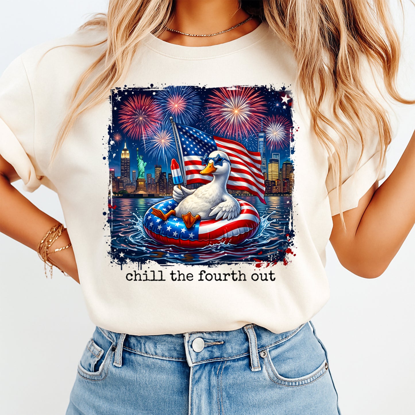 Person wearing a t-shirt with a Fourth of July design featuring a duck in an American flag inner tube.