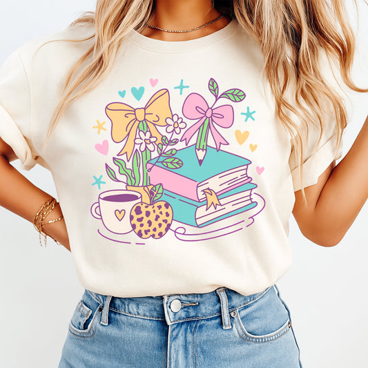 Teacher DTF transfer mockup on cream shirt with pastel books pencil bows and apple design