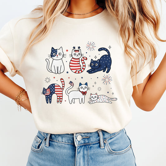 Patriotic cat DTF transfer pressed on cream shirt with red white and blue cats, stars, stripes, and fireworks design