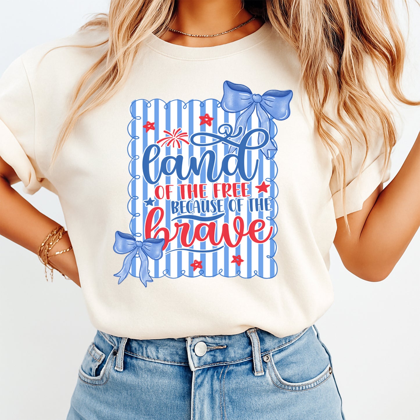 Person wearing a t-shirt with 'Land of the Free Because of the Brave' design.