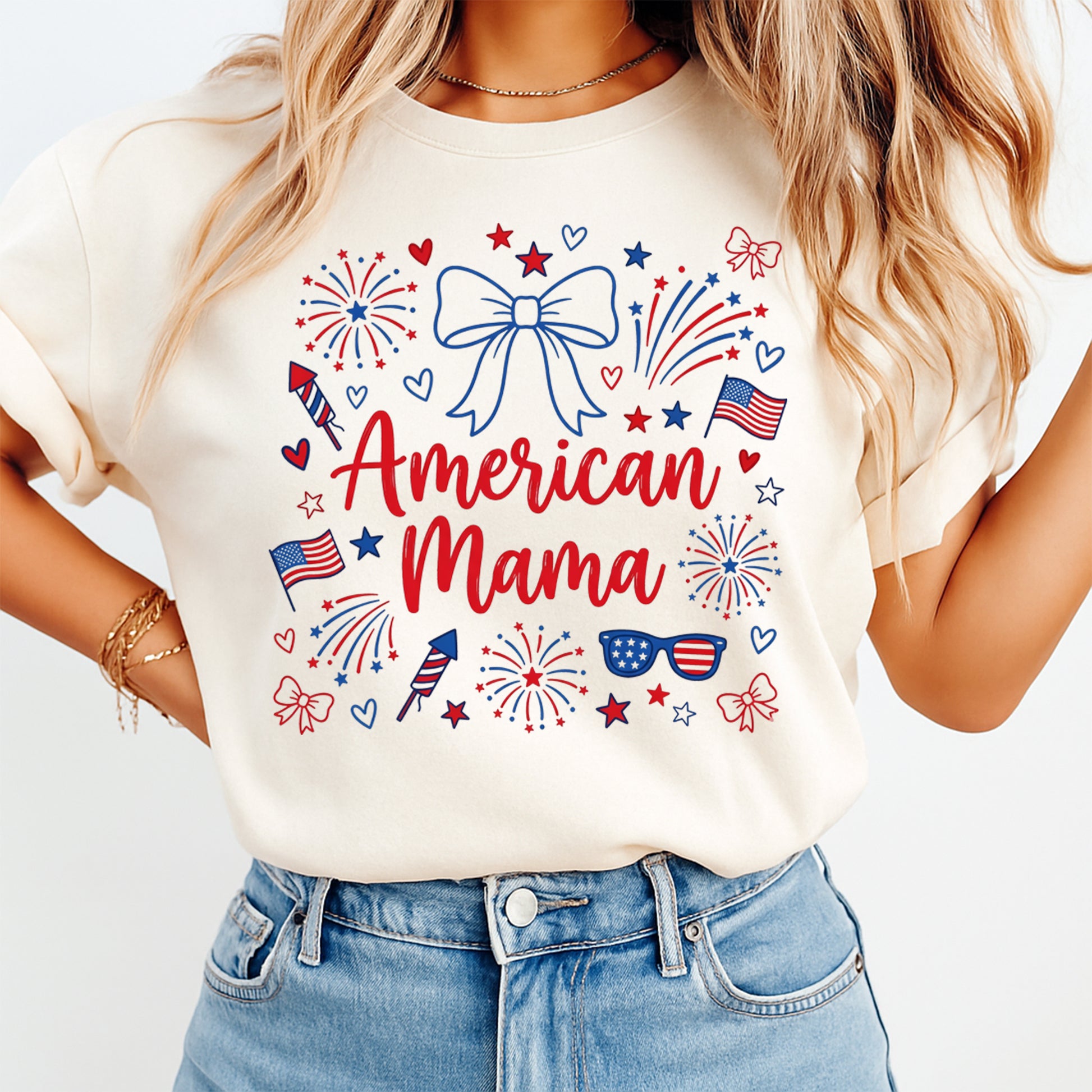 American Mama DTF transfer pressed on cream shirt with patriotic fireworks, flags, bows, hearts, stars, and sunglasses design