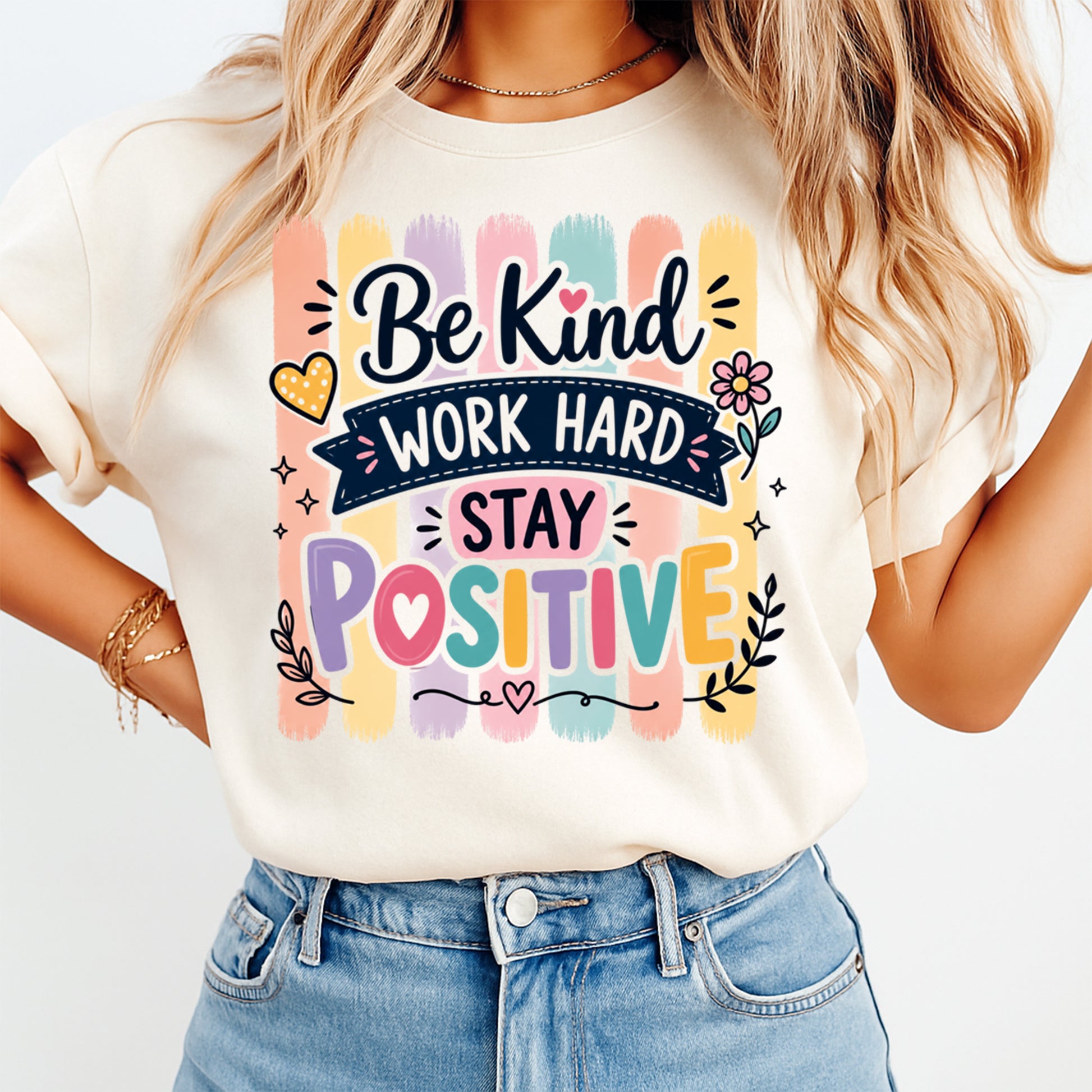 Person wearing a t-shirt with motivational quote 'Be Kind, Work Hard, Stay Positive' on a plain background