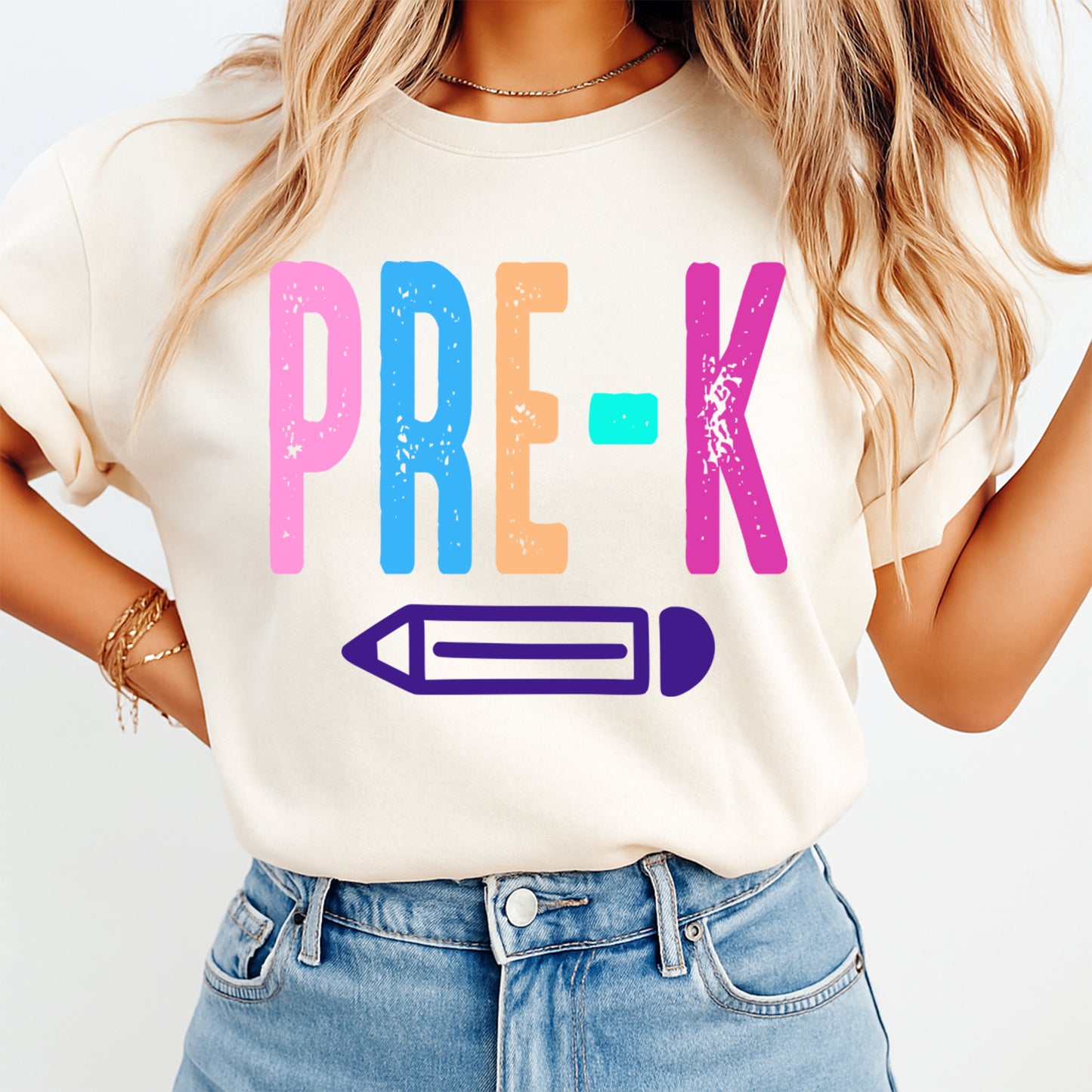 Person wearing a white t-shirt with colorful 'PRE-K' and pencil design on a plain background
