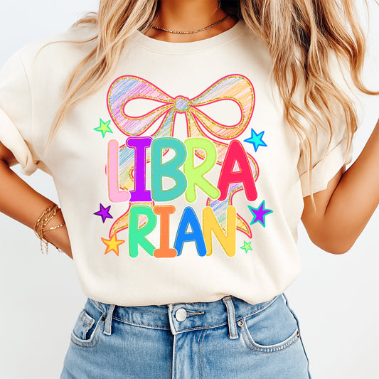 Librarian shirt mockup with colorful bow school library DTF transfer on cream T-shirt