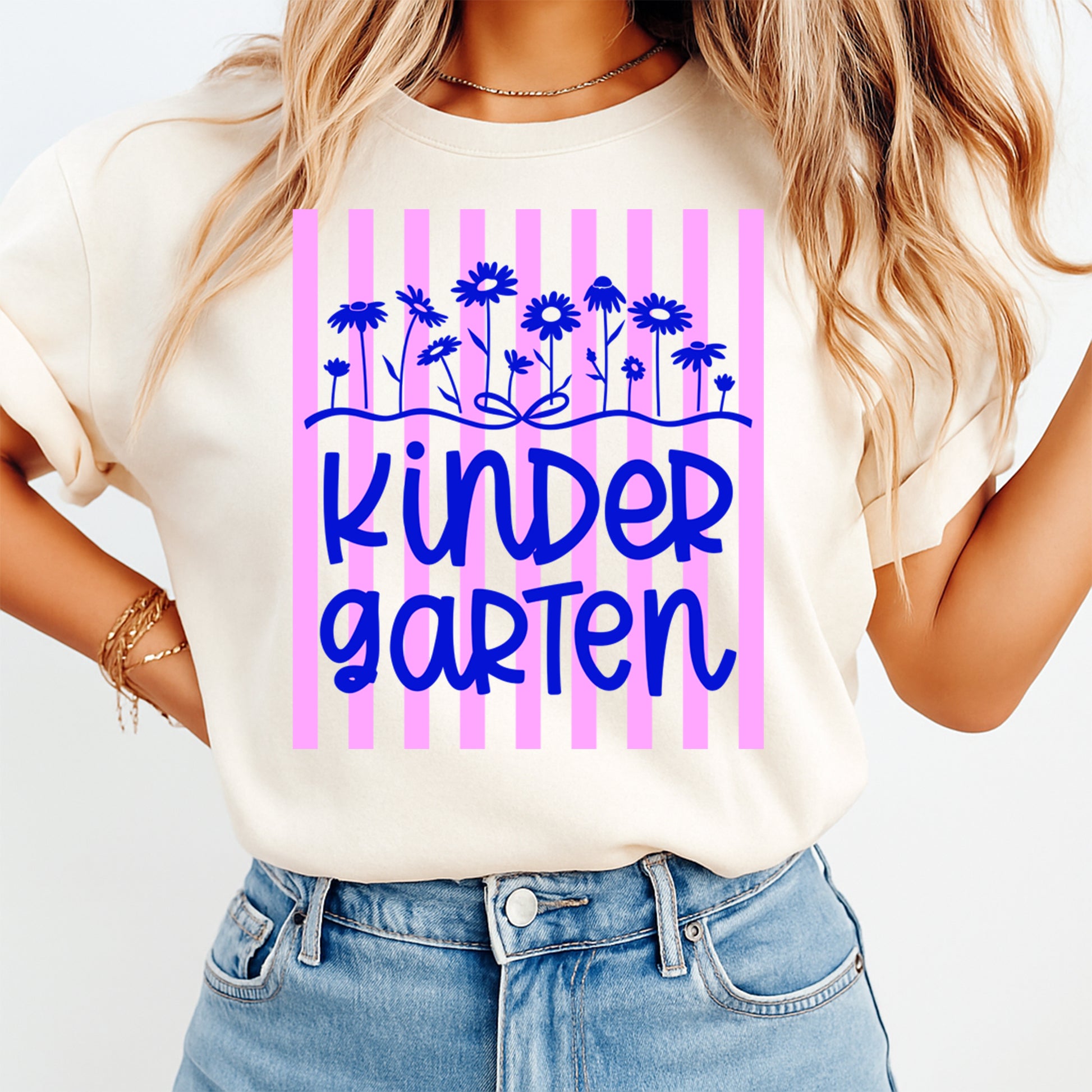 Person wearing a white t-shirt with 'KinderGarten' design on a plain background