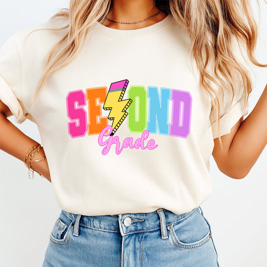 Second grade teacher shirt mockup with colorful lightning school DTF transfer on cream T-shirt