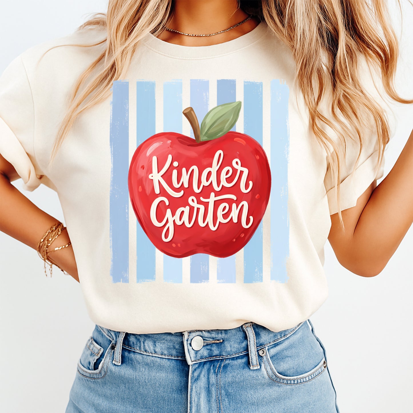 Kindergarten apple DTF transfer mockup on cream shirt with blue stripe background and school teacher design