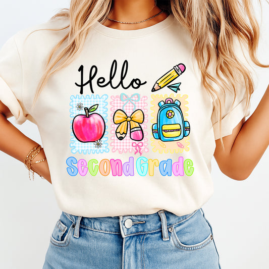 Person wearing a white t-shirt with 'Hello Second Grade' design and colorful graphics.